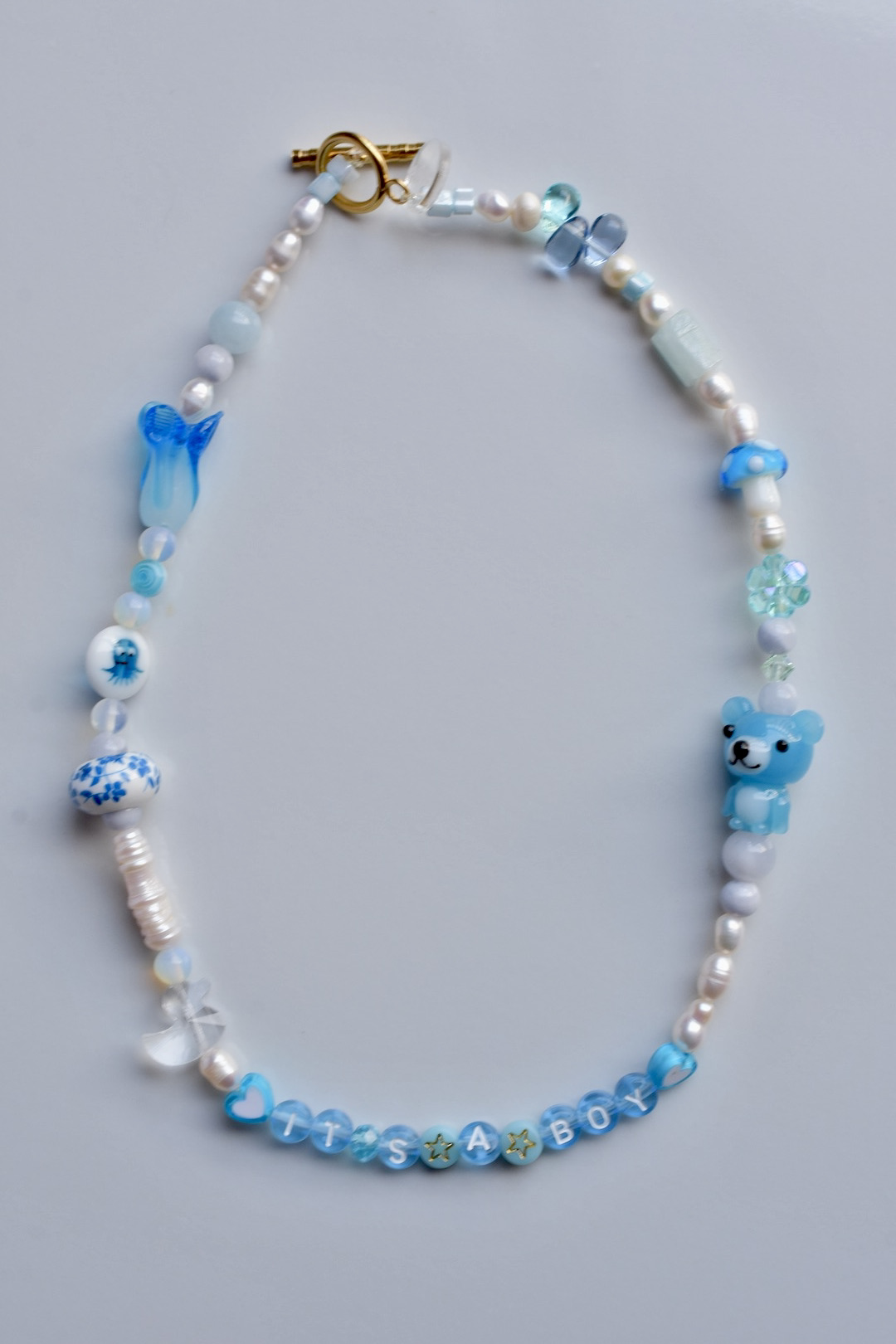 It's a boy blue pastel necklace with lucky glass beads