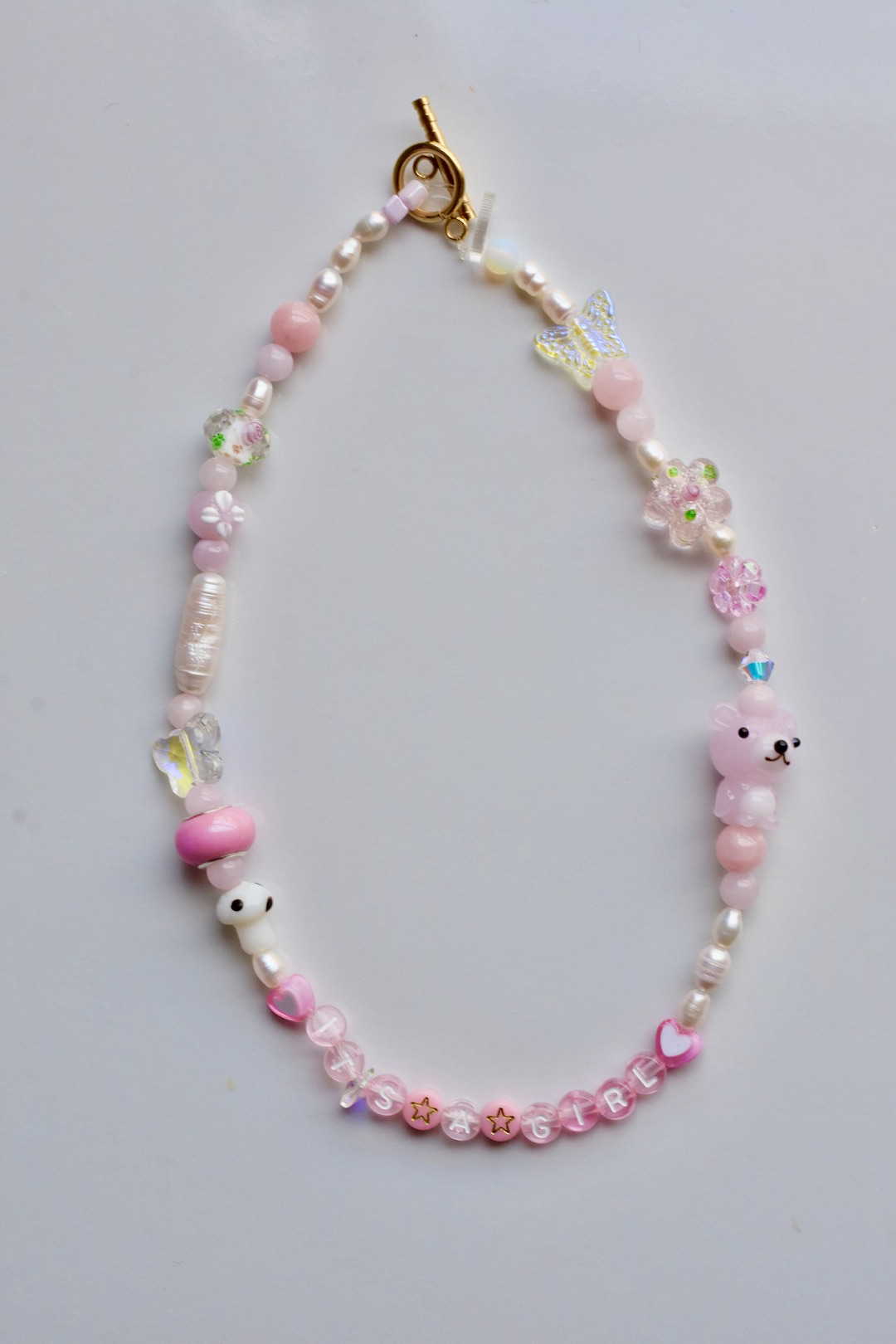 It's a girl pink choker necklace with precious beads